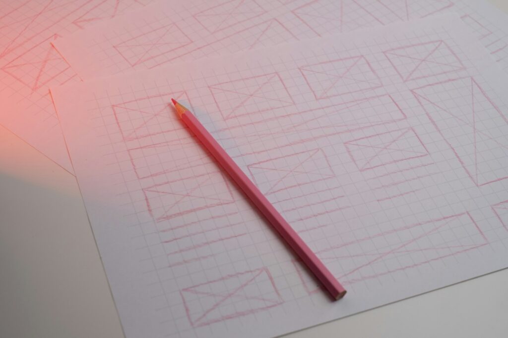 Handgezeichnete Wireframe-Skizzen auf Rasterpapier als Planung, bevor Gründer ihre Website selbst erstellen