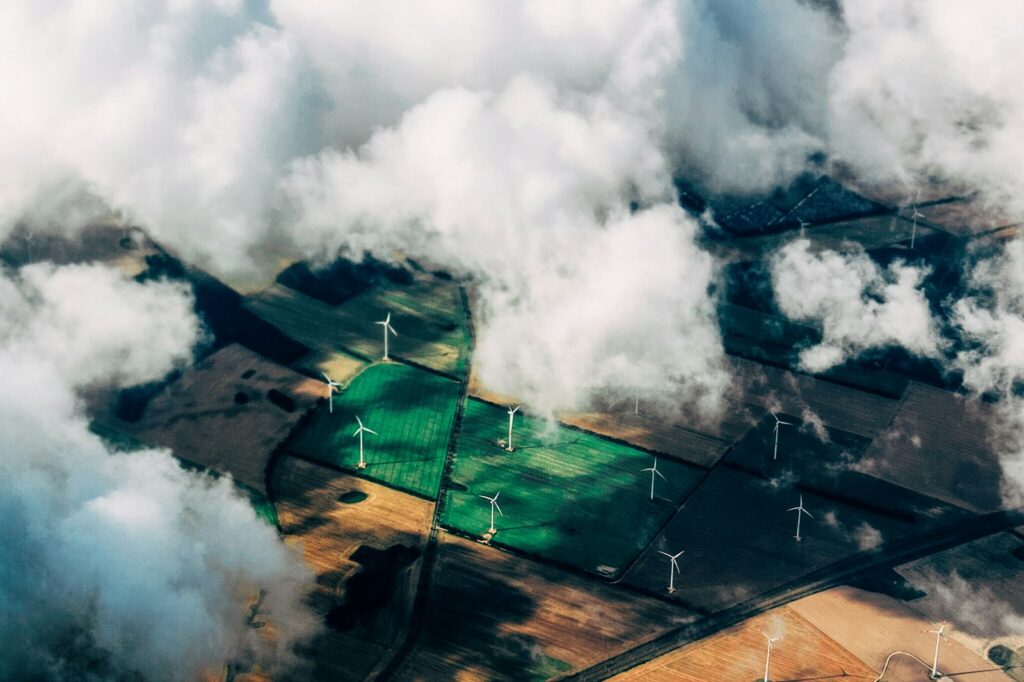 Luftbild von Windkraftanlagen zwischen landwirtschaftlichen Feldern