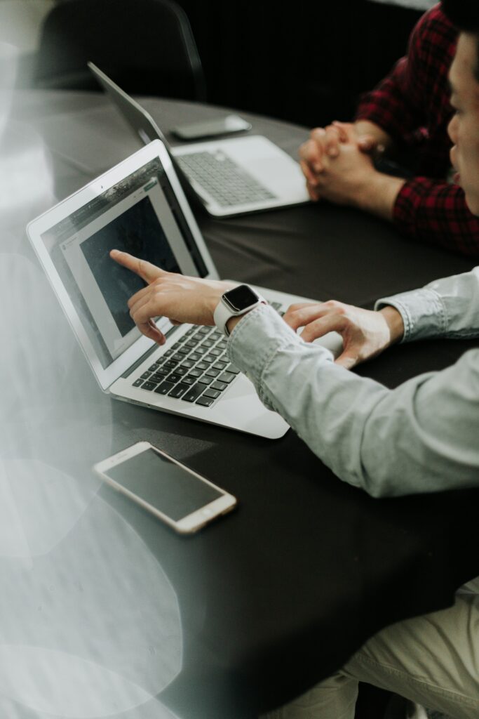 Zwei Gesellschafter einer GbR arbeiten an Laptops an ihrer Buchhaltung